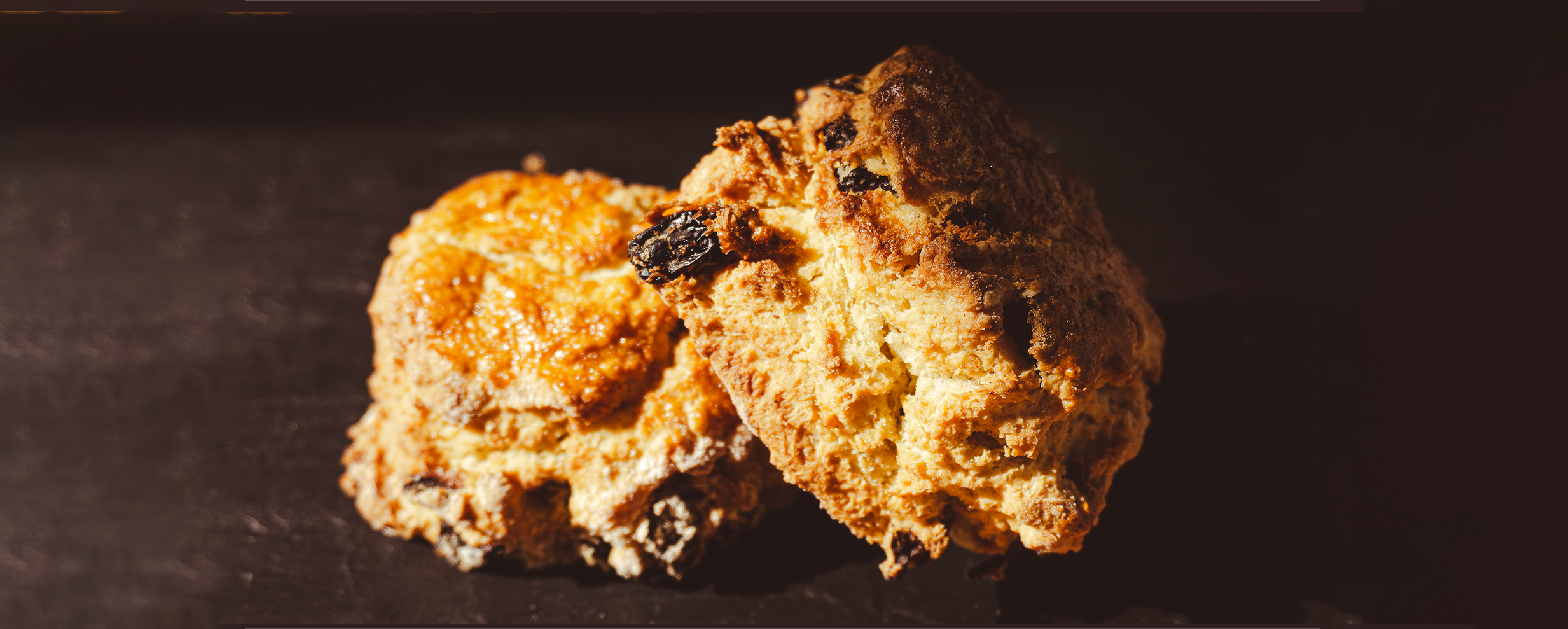 Stone wall cafe with outdoor tables behind iron fence with flowers at Caherconnell Stone Fort